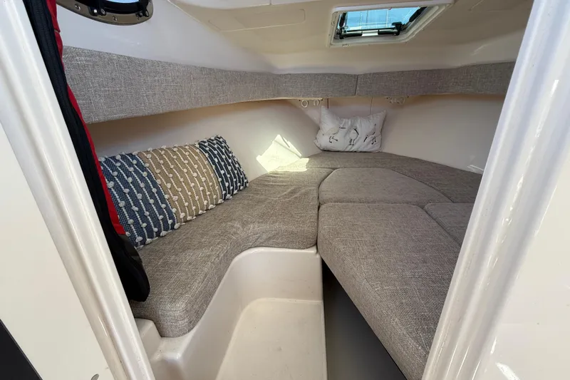  Yacht Photos Pics 2023 Grady-White Adventure 218 cabin interior with cozy seating and cushions.