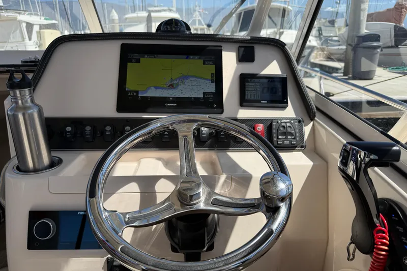  Yacht Photos Pics Helm of 2023 Grady-White Adventure 218 with navigation screens and steering wheel.