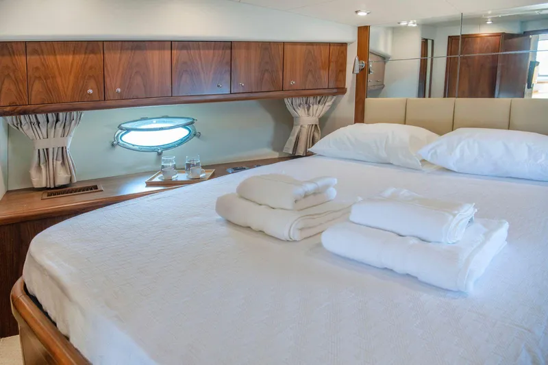 Yoda Yacht Photos Pics Luxurious bedroom interior of 2008 Sunseeker Predator 62 yacht with elegant wood finishes.