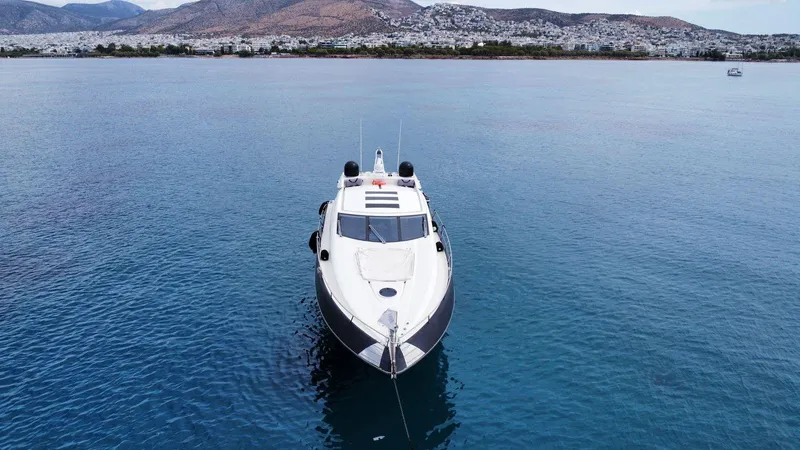 Yoda Yacht Photos Pics 2008 Sunseeker Predator 62 yacht on calm water with mountainous backdrop.