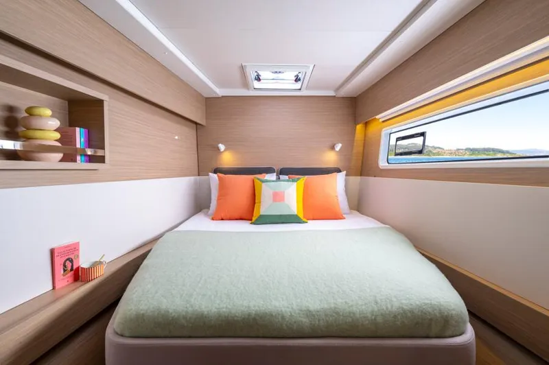  Yacht Photos Pics Luxurious cabin interior of 2024 Lagoon 43 yacht with modern decor and large window.