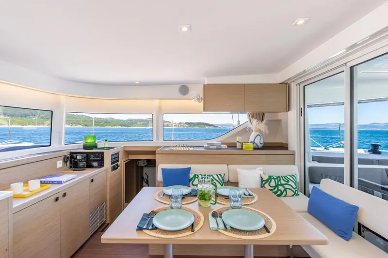  Yacht Photos Pics Interior of 2024 Lagoon 43 yacht with dining area, ocean view, and modern decor.