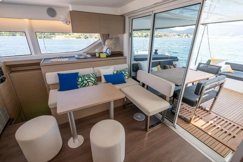  Yacht Photos Pics Modern interior of 2024 Lagoon 43 yacht with seating and dining area.