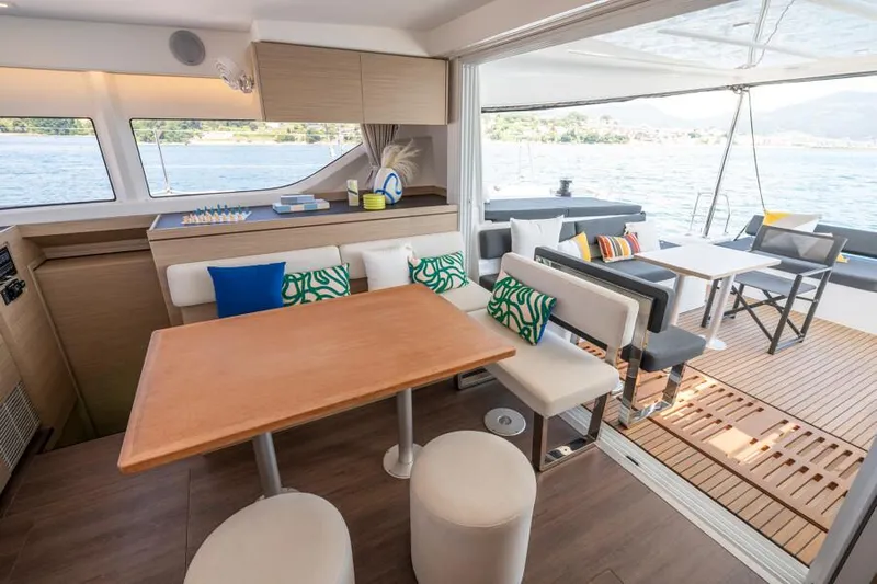  Yacht Photos Pics Luxurious interior of 2024 Lagoon 43 yacht with modern dining area and scenic water view.
