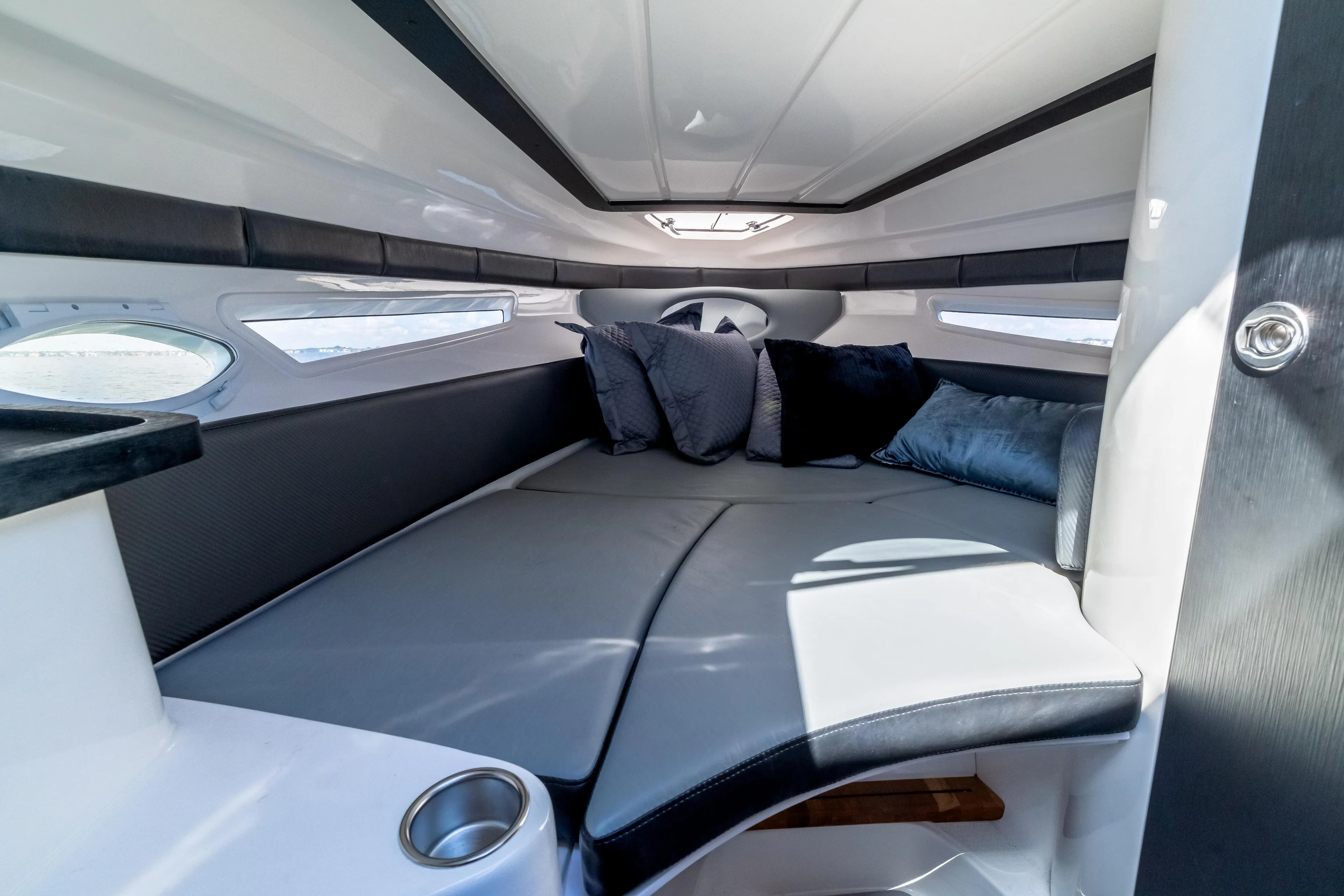  Yacht Photos Pics Luxurious interior cabin of 2025 Hanover 305 boat with plush seating and cushions.