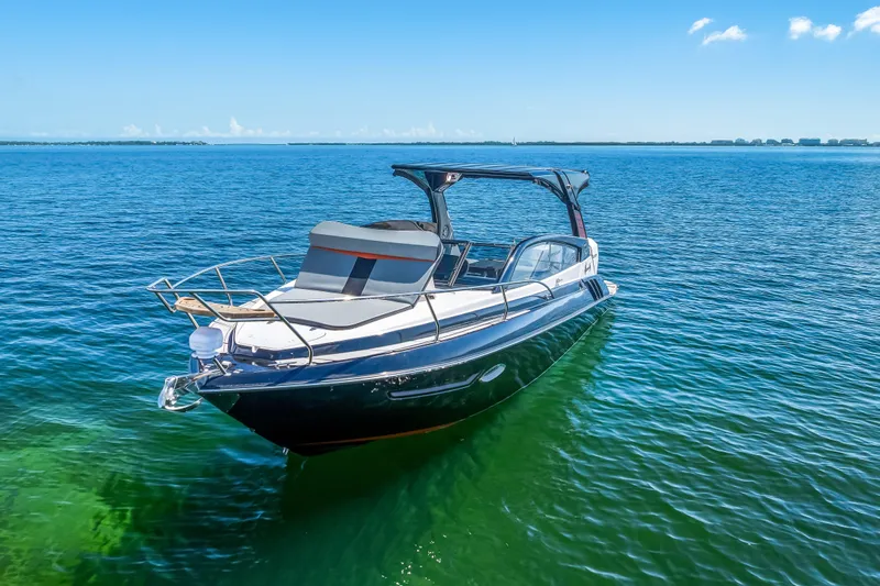  Yacht Photos Pics 2025 Hanover 305 boat on clear blue water under a sunny sky.
