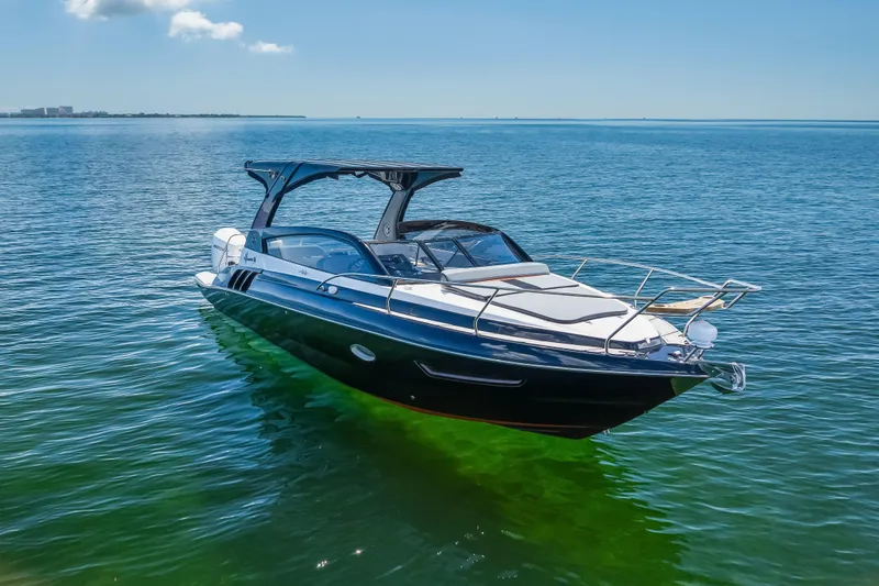  Yacht Photos Pics Luxurious 2025 Hanover 305 yacht cruising on clear blue waters under a sunny sky.
