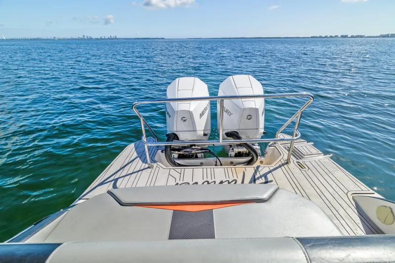  Yacht Photos Pics 2025 Hanover 305 boat with dual Mercury engines on open water.