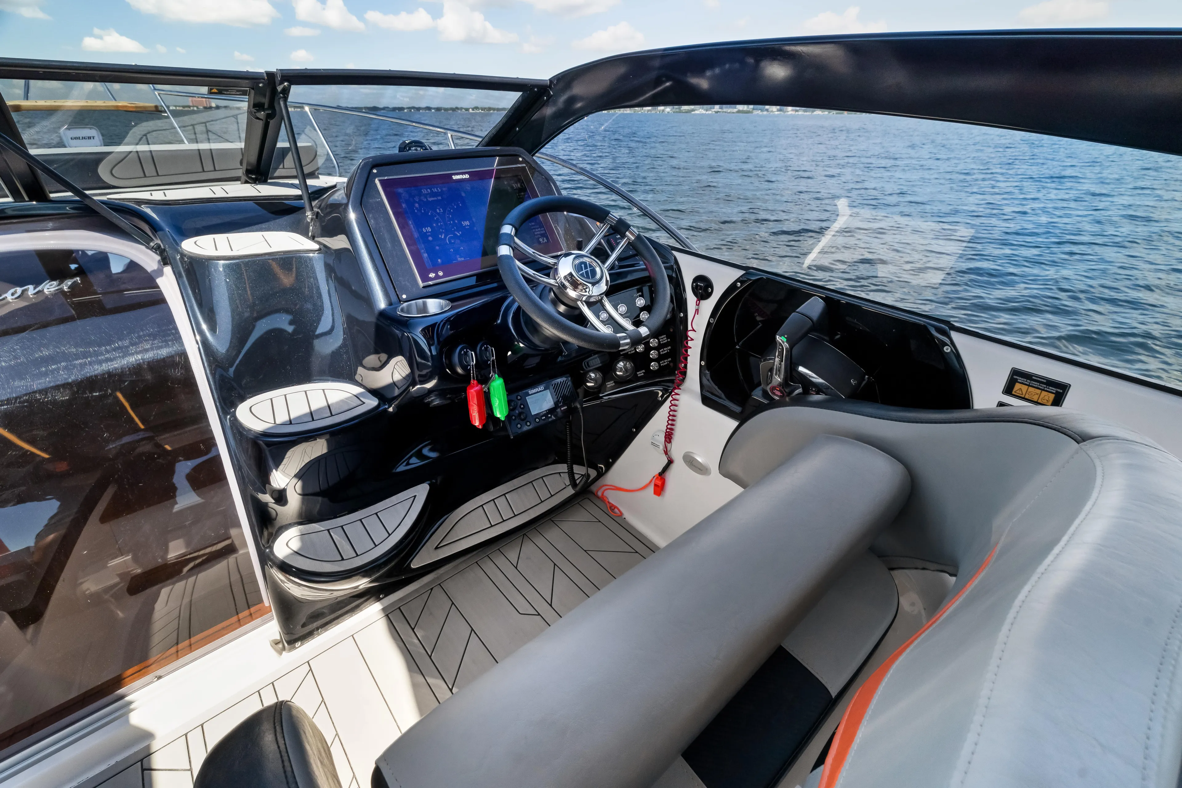  Yacht Photos Pics Interior of 2025 Hanover 305 boat with modern dashboard and steering wheel on open water.