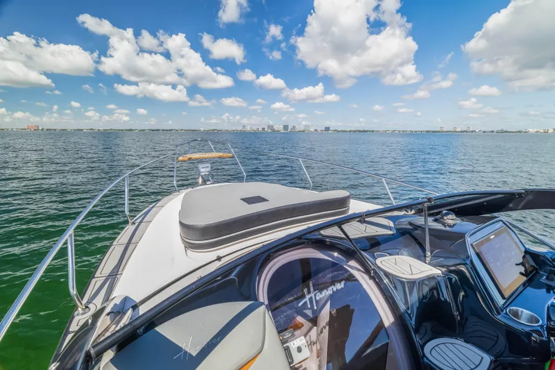  Yacht Photos Pics Luxury Hanover 305 yacht cruising on open water under a clear blue sky, 2025 model.