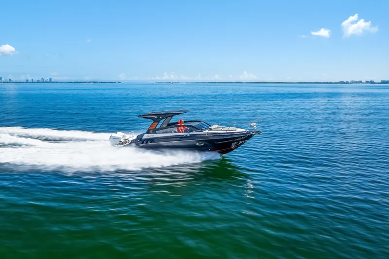  Yacht Photos Pics 2025 Hanover 305 boat cruising on open water under clear blue sky.