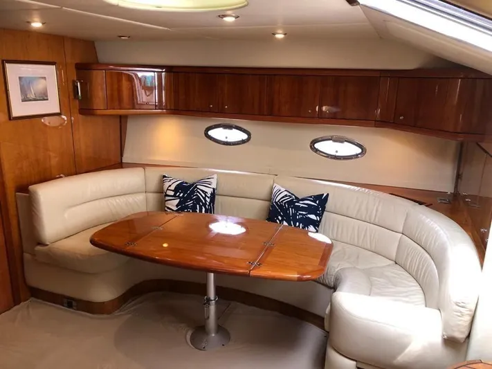  Yacht Photos Pics Luxurious interior of 2003 Sunseeker Portofino 46 yacht with elegant seating and wooden table.