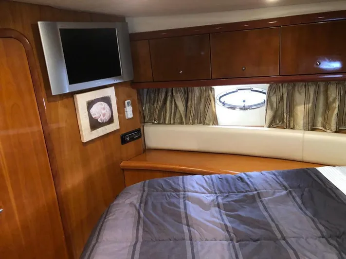  Yacht Photos Pics Interior of 2003 Sunseeker Portofino 46 yacht with wood paneling and TV.