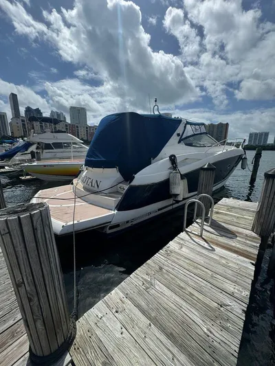  Yacht Photos Pics 2003 Sunseeker Portofino 46 yacht docked at marina under cloudy sky.