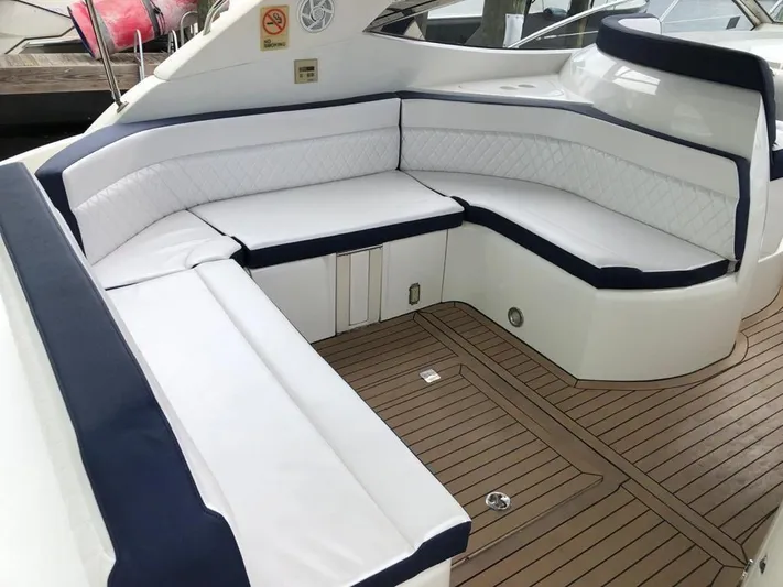  Yacht Photos Pics Luxurious seating area on a 2003 Sunseeker Portofino 46 yacht with white cushions.
