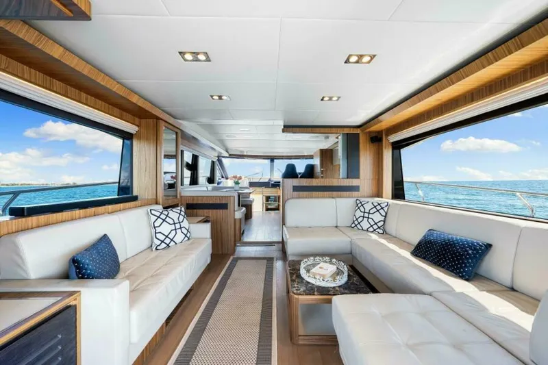 Mama's House Yacht Photos Pics Luxurious interior of 2018 Absolute 60 Flybridge yacht with elegant seating and ocean view.
