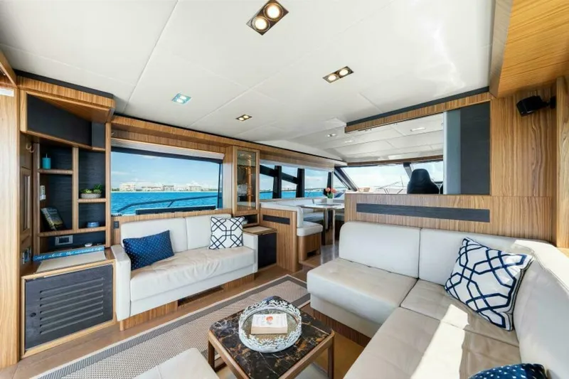 Mama's House Yacht Photos Pics Luxurious interior of 2018 Absolute 60 Flybridge yacht with elegant seating and ocean view.