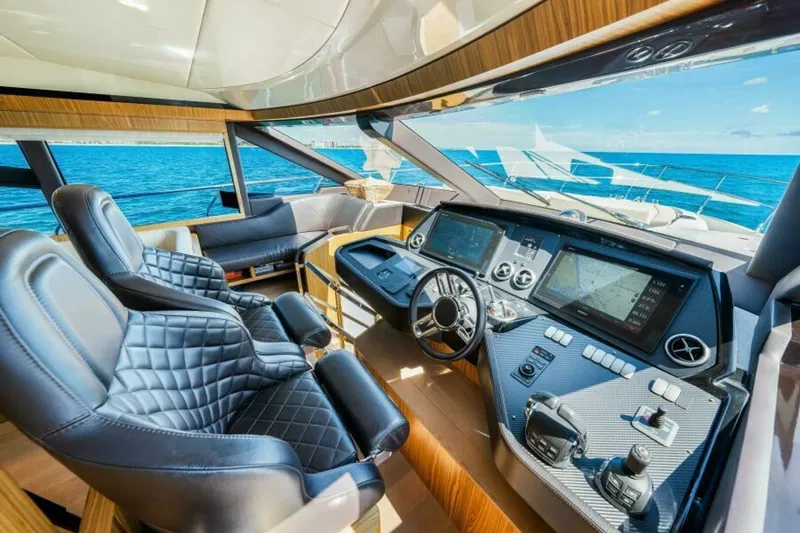 Mama's House Yacht Photos Pics Luxurious interior of 2018 Absolute 60 Flybridge yacht with modern helm and ocean view.