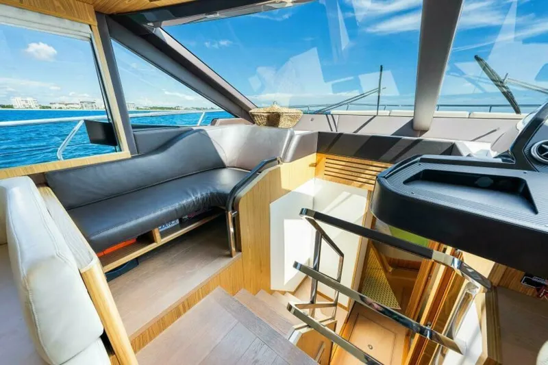 Mama's House Yacht Photos Pics Luxurious interior of 2018 Absolute 60 Flybridge yacht with modern seating and ocean view.