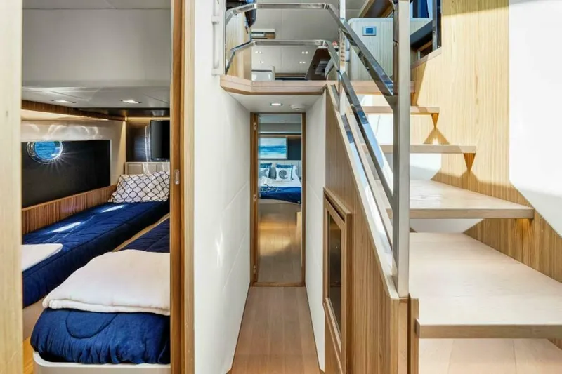 Mama's House Yacht Photos Pics Luxurious interior of 2018 Absolute 60 Flybridge yacht with modern staircase and cozy cabin.