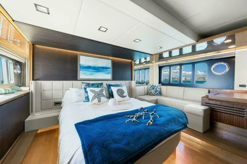 Mama's House Yacht Photos Pics Luxurious bedroom interior on 2018 Absolute 60 Flybridge yacht with ocean-themed decor.