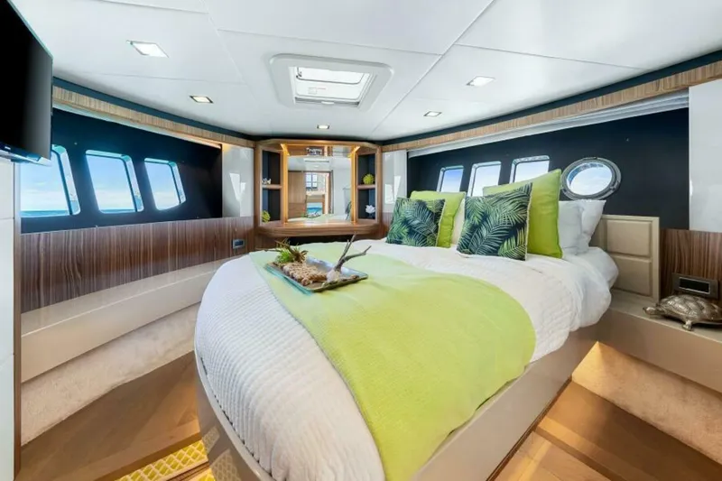 Mama's House Yacht Photos Pics Luxurious bedroom interior of 2018 Absolute 60 Flybridge yacht with modern decor and ocean views.