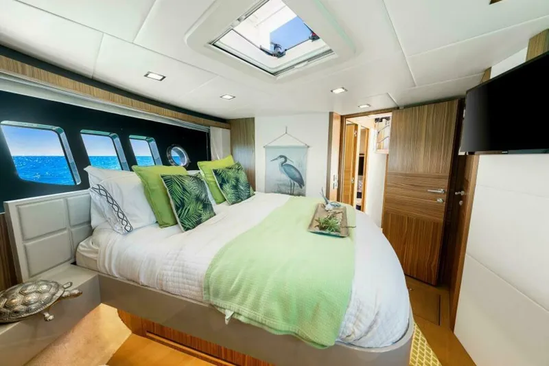 Mama's House Yacht Photos Pics Luxurious bedroom interior on 2018 Absolute 60 Flybridge yacht with ocean view windows.