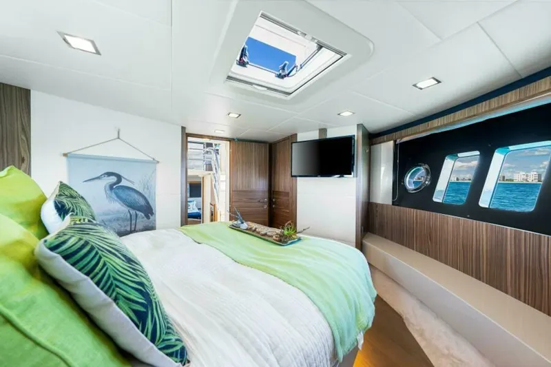 Mama's House Yacht Photos Pics Luxurious bedroom interior of 2018 Absolute 60 Flybridge yacht with ocean view windows.