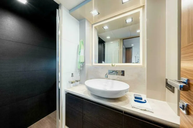 Mama's House Yacht Photos Pics Luxurious bathroom in 2018 Absolute 60 Flybridge yacht, featuring modern sink and elegant design.