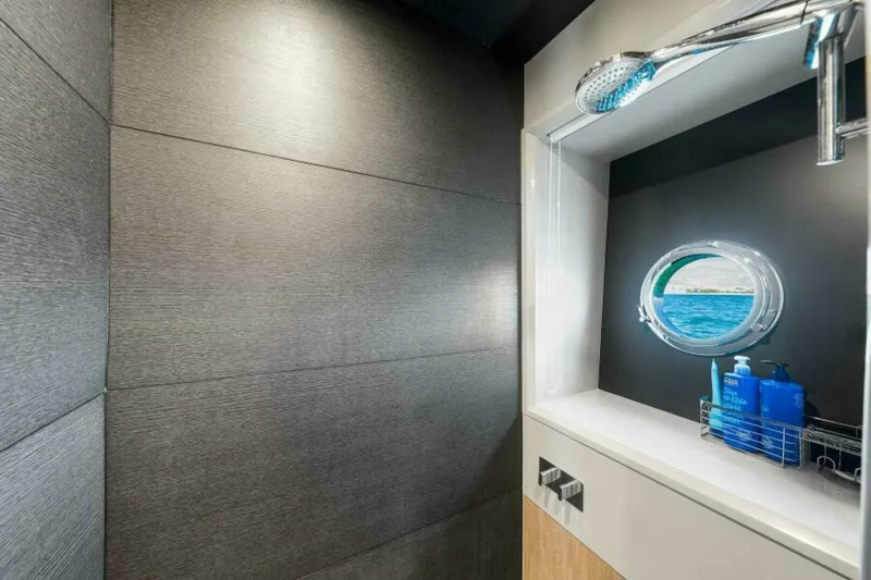 Mama's House Yacht Photos Pics Luxurious bathroom on 2018 Absolute 60 Flybridge yacht with ocean view porthole.