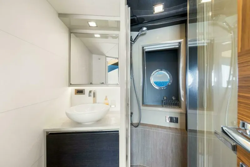 Mama's House Yacht Photos Pics Luxurious bathroom on 2018 Absolute 60 Flybridge yacht with modern fixtures and ocean view.