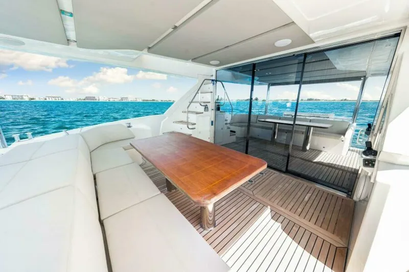 Mama's House Yacht Photos Pics Luxurious 2018 Absolute 60 Flybridge yacht with spacious deck and ocean view.