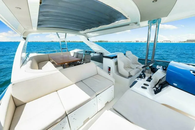 Mama's House Yacht Photos Pics Luxurious 2018 Absolute 60 Flybridge yacht interior with ocean view and elegant seating.