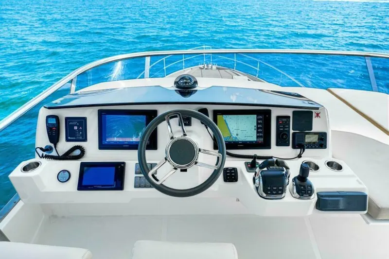 Mama's House Yacht Photos Pics Cockpit of 2018 Absolute 60 Flybridge yacht with navigation equipment and ocean view.