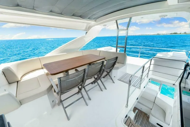 Mama's House Yacht Photos Pics Luxurious 2018 Absolute 60 Flybridge yacht with elegant seating and ocean view.