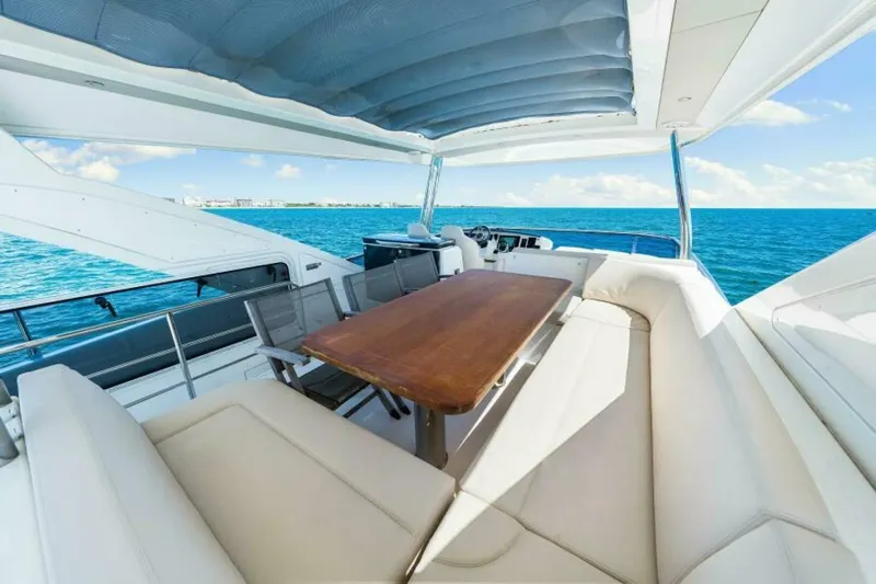 Mama's House Yacht Photos Pics Luxurious 2018 Absolute 60 Flybridge yacht with spacious seating and ocean view.