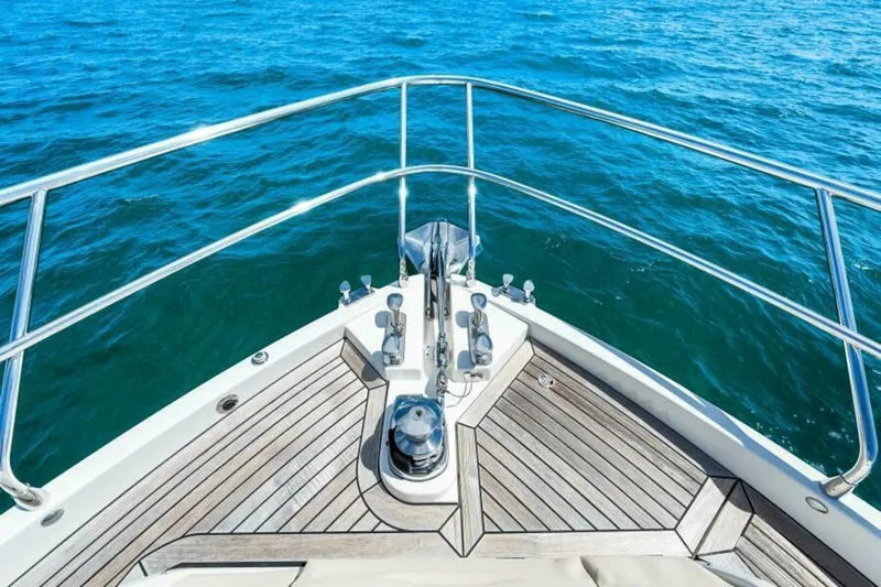 Mama's House Yacht Photos Pics Bow view of 2018 Absolute 60 Flybridge yacht on open water.