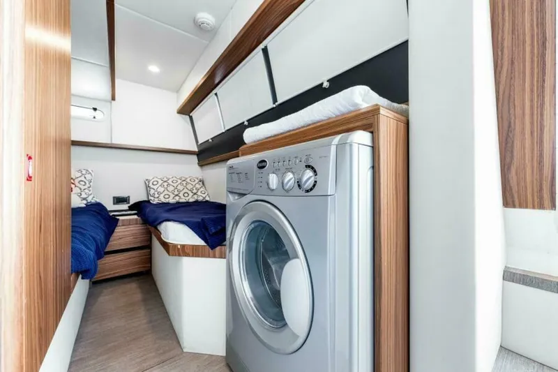 Mama's House Yacht Photos Pics Interior of 2018 Absolute 60 Flybridge yacht with twin beds and washing machine.
