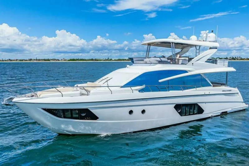 Mama's House Yacht Photos Pics Luxury 2018 Absolute 60 Flybridge yacht cruising on open water under blue skies.