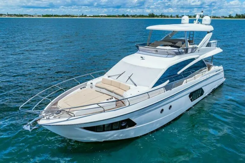 Mama's House Yacht Photos Pics Luxurious 2018 Absolute 60 Flybridge yacht cruising on open water.
