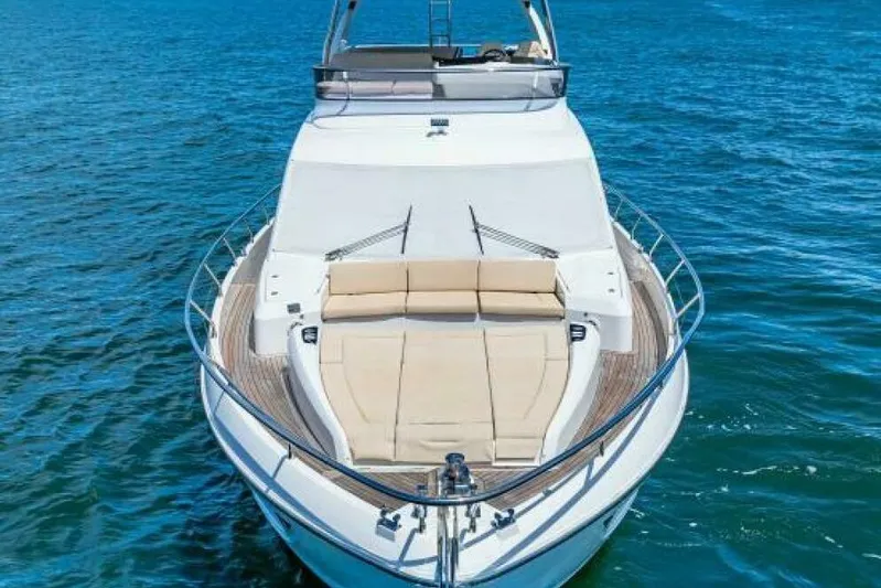 Mama's House Yacht Photos Pics Luxury 2018 Absolute 60 Flybridge yacht on open water, featuring spacious deck seating.