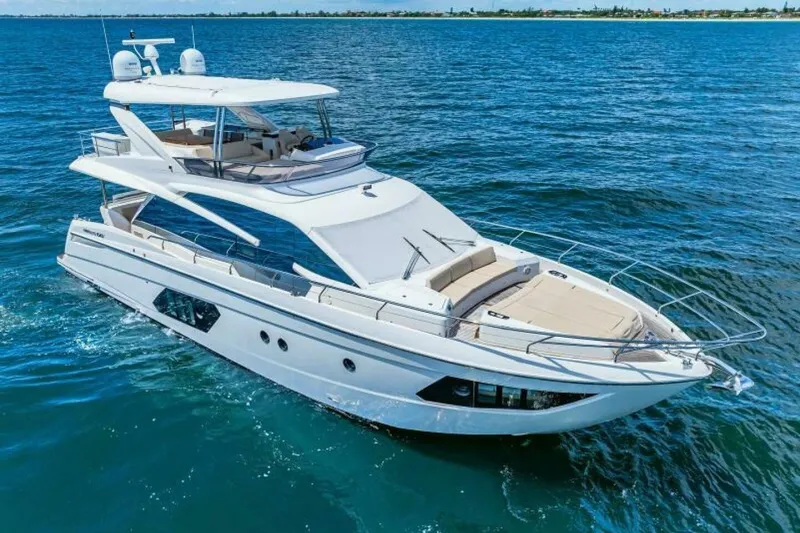 Mama's House Yacht Photos Pics Luxurious 2018 Absolute 60 Flybridge yacht cruising on open water.