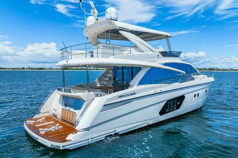 Mama's House Yacht Photos Pics Luxury 2018 Absolute 60 Flybridge yacht cruising on open water under blue skies.