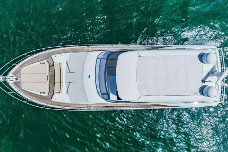 Mama's House Yacht Photos Pics Aerial view of 2018 Absolute 60 Flybridge yacht on turquoise water.