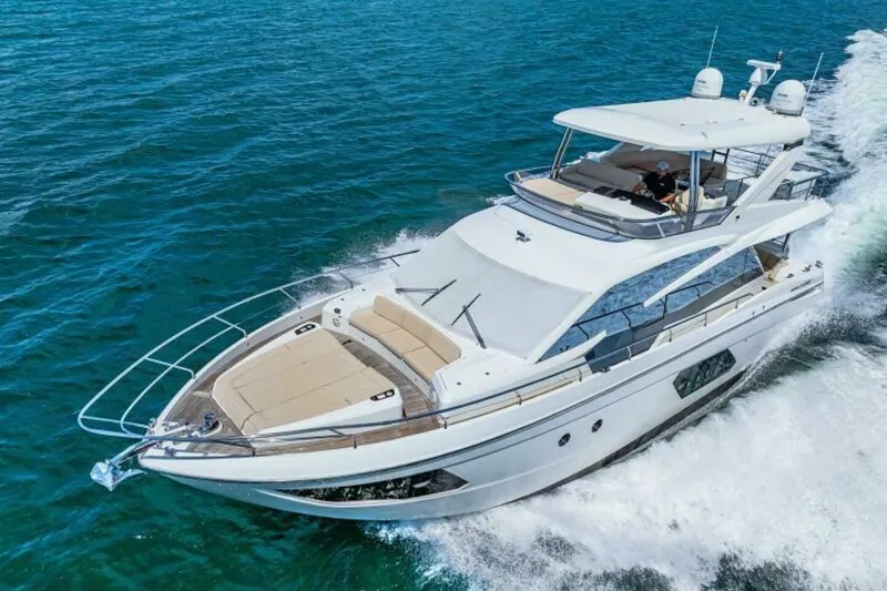 Mama's House Yacht Photos Pics Luxurious 2018 Absolute 60 Flybridge yacht cruising on open water.