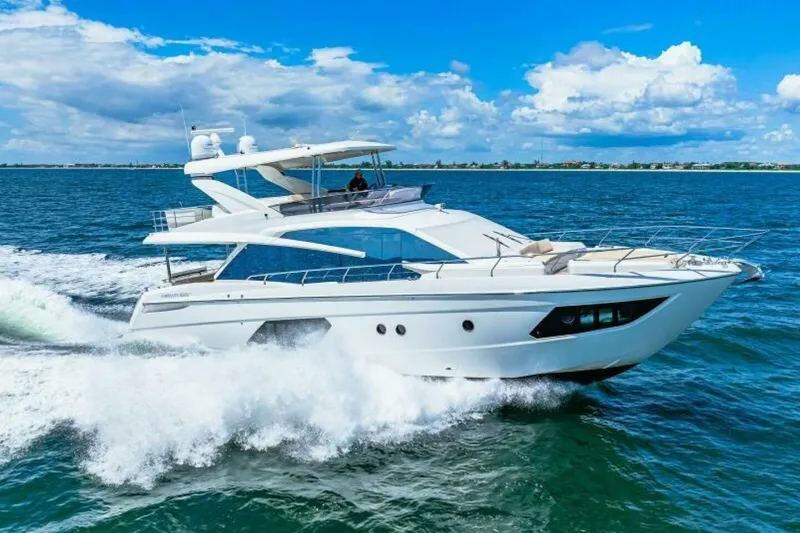 Mama's House Yacht Photos Pics 2018 Absolute 60 Flybridge yacht cruising on open water under a clear blue sky.