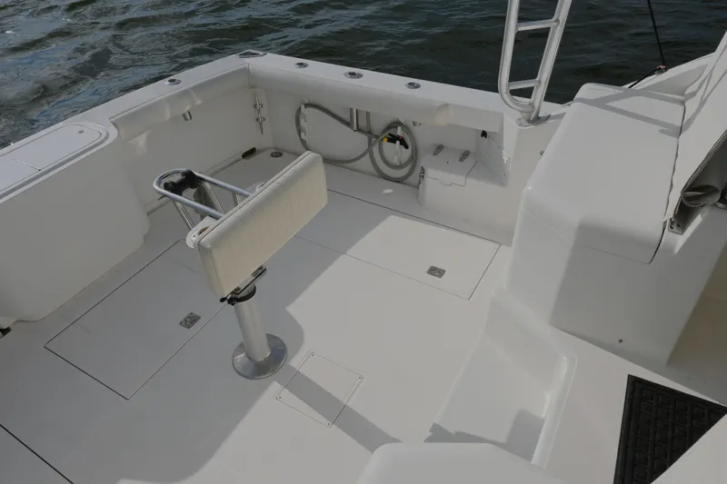 Done Deal Yacht Photos Pics 2001 Cabo 35 Express boat deck with seating and fishing rod holders.