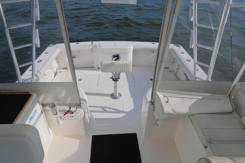 Done Deal Yacht Photos Pics 2001 Cabo 35 Express boat interior with seating and fishing rod holders.