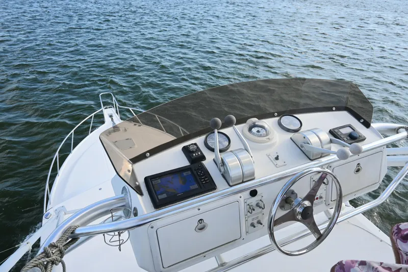 Done Deal Yacht Photos Pics Helm of 2001 Cabo 35 Express boat with navigation equipment on calm water.