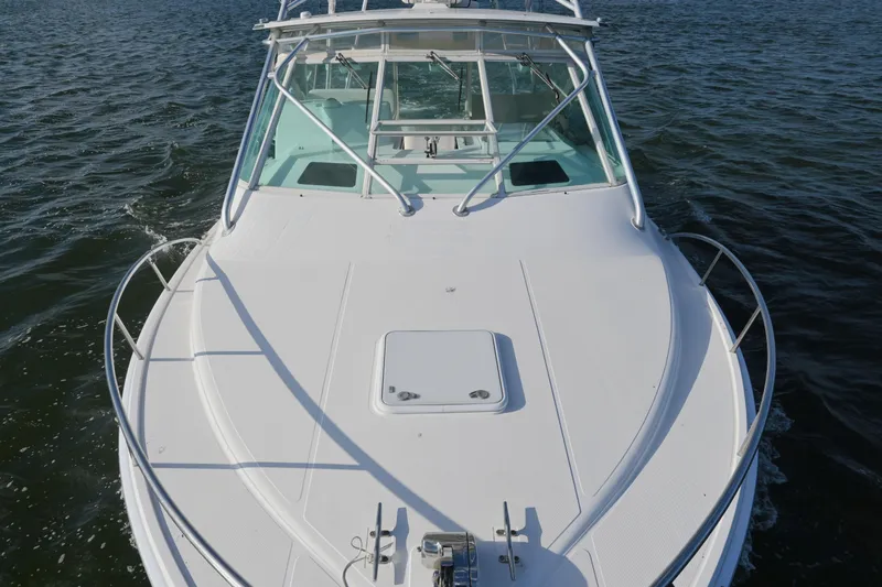 Done Deal Yacht Photos Pics 2001 Cabo 35 Express boat cruising on open water, showcasing sleek design and sturdy build.